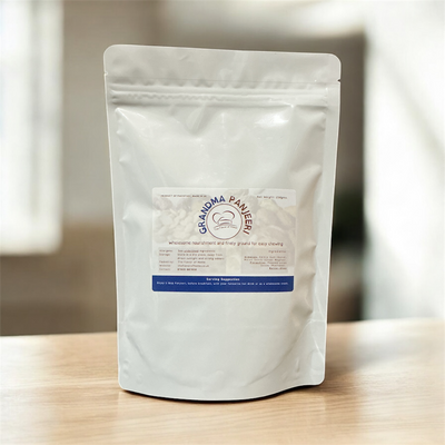 White packaging of Grandma Panjeeri on a wooden surface with a blurred background