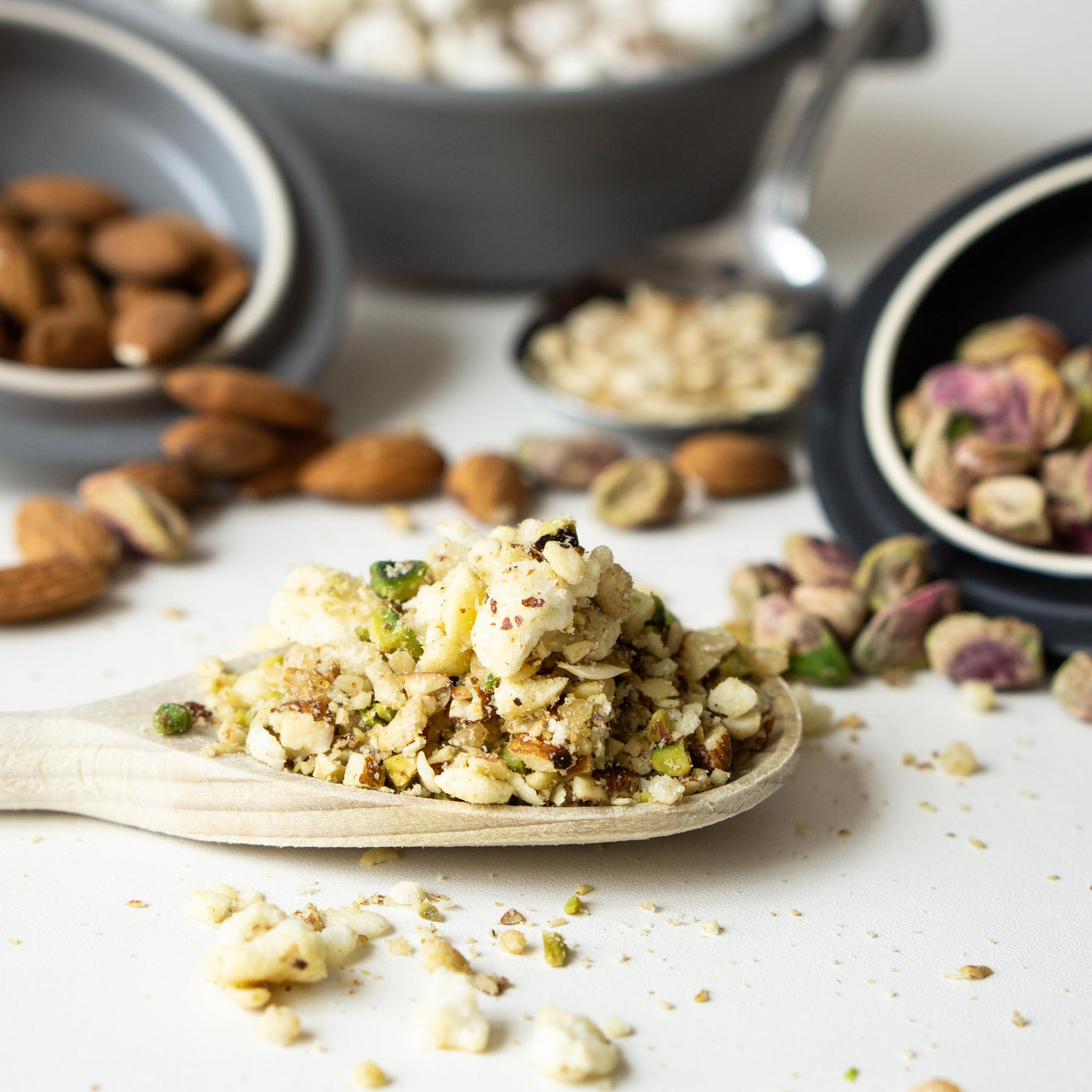 Nuts and seeds on a wooden spoon with a light background